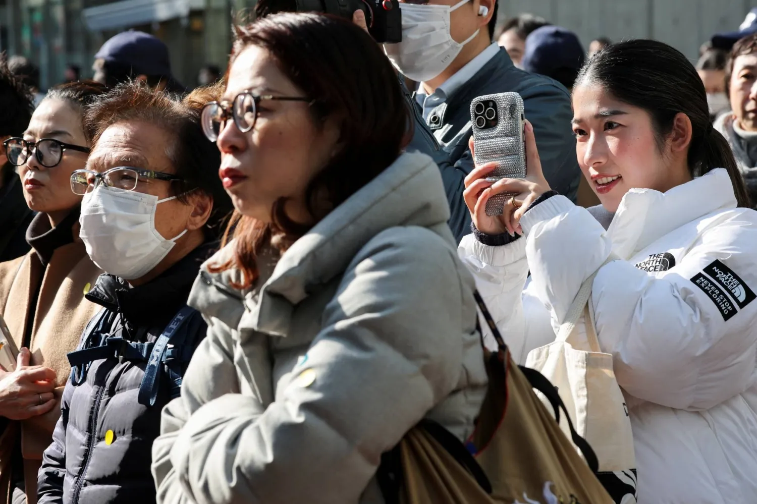 Voters listen to a speech by Prime Minister Sanae Takaichi in Tokyo on Tuesday, the first day of campaigning for the Feb. 8 Lower House election. | REUTERS